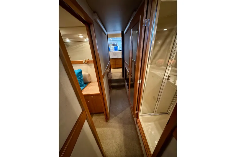 Slide: The Image of Hallway inside 2000 Bayliner 4788 Pilot House Motoryacht, featuring wood accents and cozy cabin. - 45