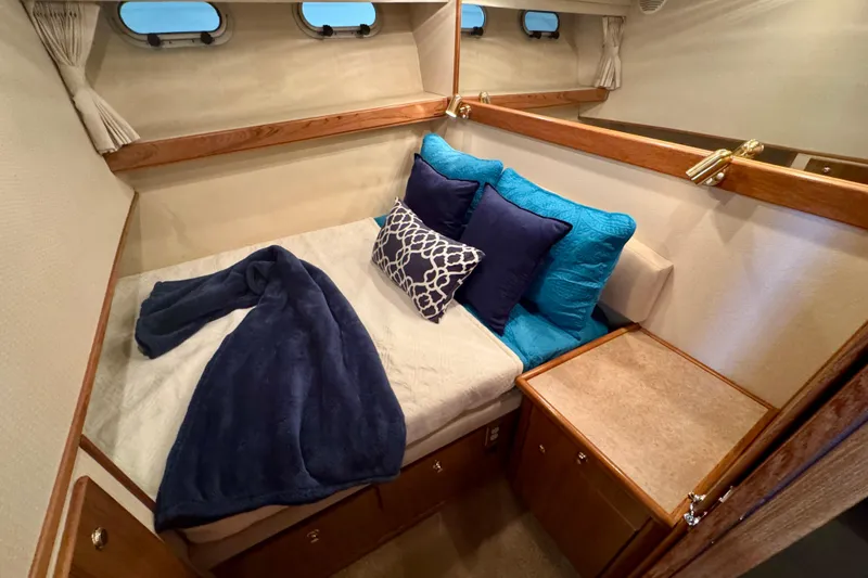 Slide: The Image of Cozy cabin interior of 2000 Bayliner 4788 Pilot House Motoryacht with plush bedding. - 46