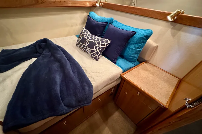 Slide: The Image of Cozy bedroom in 2000 Bayliner 4788 Pilot House Motoryacht with plush pillows and blanket. - 47