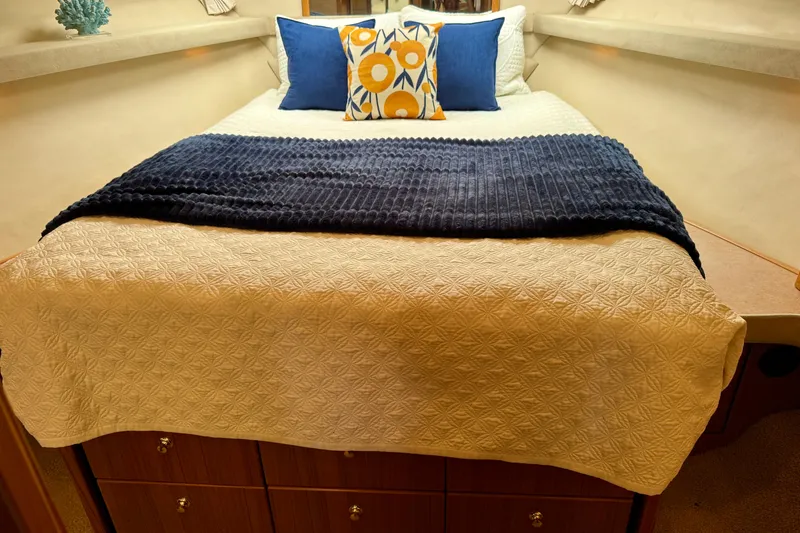 Slide: The Image of Cozy bedroom interior of 2000 Bayliner 4788 Pilot House Motoryacht with decorative pillows. - 53