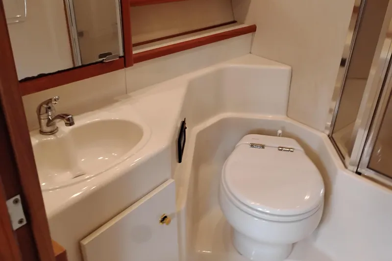Slide: The Image of Bathroom interior of 2000 Bayliner 4788 Pilot House Motoryacht, featuring sink and toilet. - 58