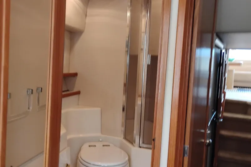 Slide: The Image of Interior bathroom of 2000 Bayliner 4788 Pilot House Motoryacht, featuring toilet and shower. - 59