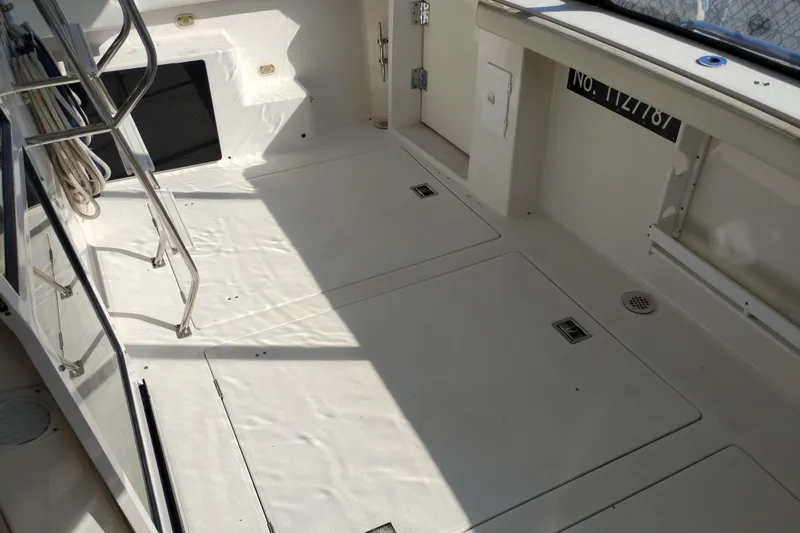 Slide: The Image of 2000 Bayliner 4788 Pilot House Motoryacht deck with ladder and storage compartments. - 6