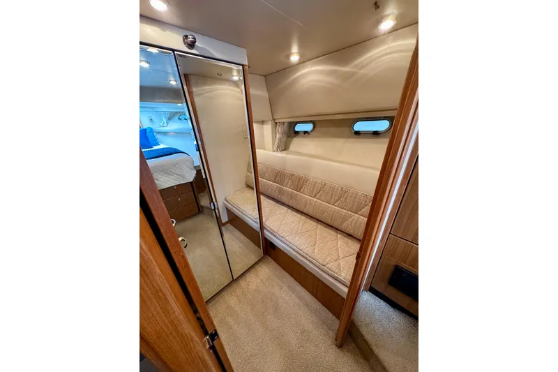 Slide: The Image of Interior of 2000 Bayliner 4788 Pilot House Motoryacht with cozy seating and mirrored closet. - 60
