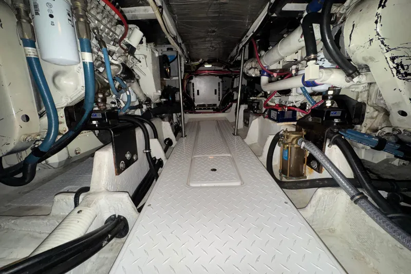 Slide: The Image of Engine room of 2000 Bayliner 4788 Pilot House Motoryacht, showcasing mechanical components and systems. - 61
