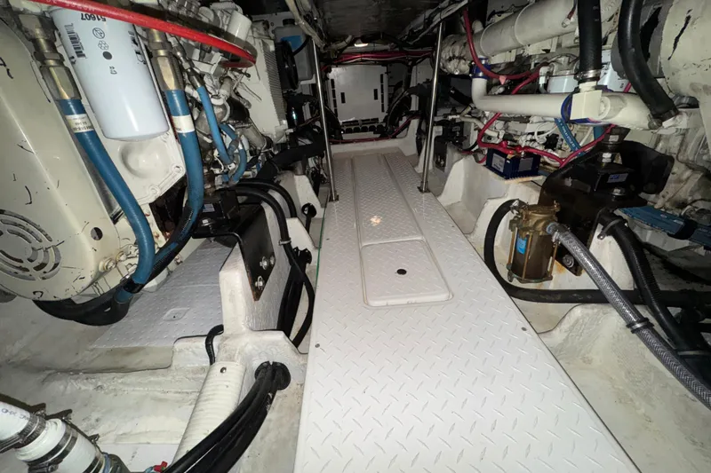 Slide: The Image of Engine room of 2000 Bayliner 4788 Pilot House Motoryacht with visible machinery and components. - 64