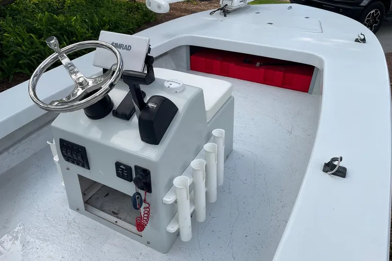 Slide: The Image of 2023 Riptide 17 Flats boat interior with steering console and rod holders. - 11