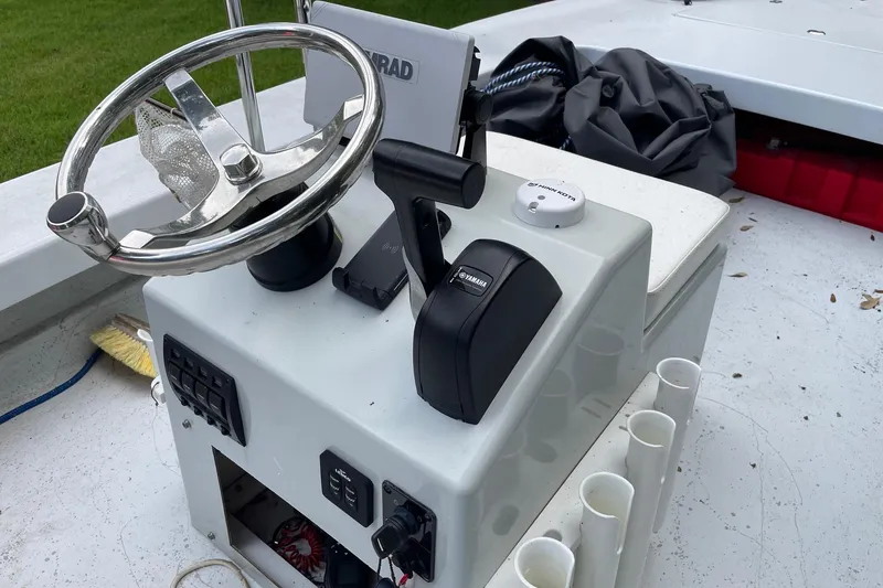 Slide: The Image of 2023 Riptide 17 Flats boat console with steering wheel and controls. - 15