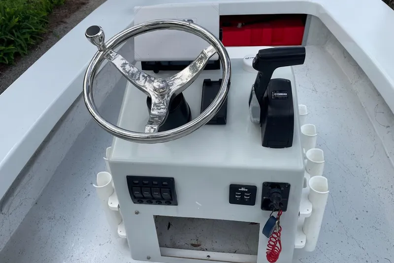 Slide: The Image of 2023 Riptide 17 Flats boat console with steering wheel and controls. - 16