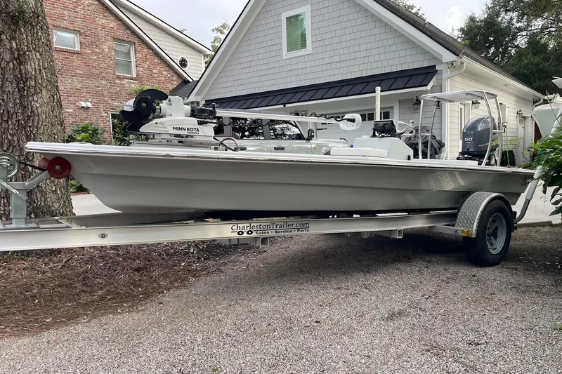 Slide: The Image of 2023 Riptide 17 Flats boat on trailer, parked in residential driveway. - 4