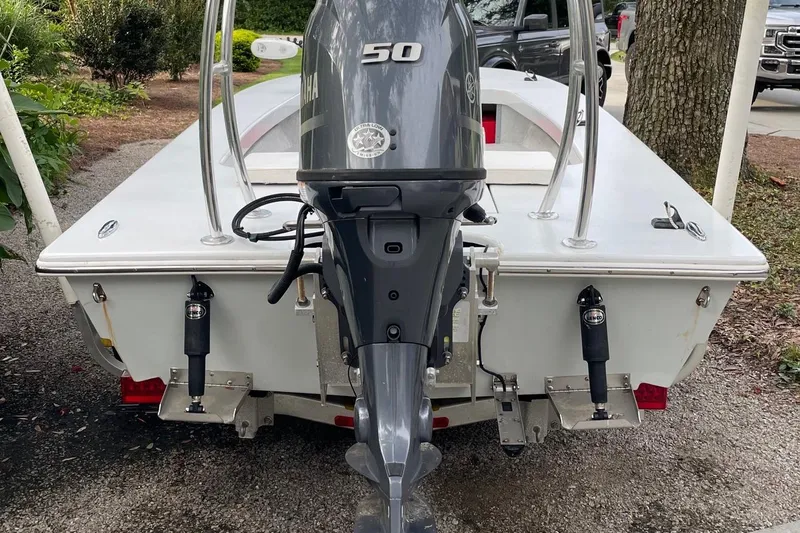 Slide: The Image of 2023 Riptide 17 Flats boat with Yamaha 50 outboard motor, parked outdoors. - 6