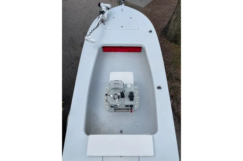 Slide: The Image of 2023 Riptide 17 Flats boat interior with steering console and rod holders. - 7