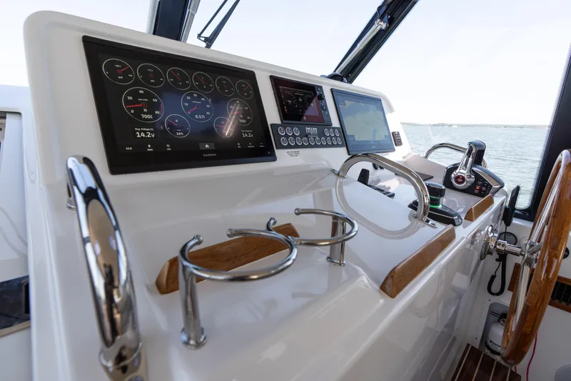 Slide: The Image of 2023 MJM Yachts 4 interior with helm, luxurious seating, and wooden accents. - 10