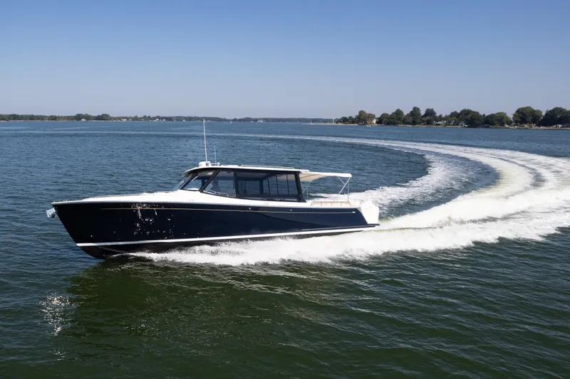 Slide: The Image of Luxury seating detail on 2023 MJM Yachts 4, featuring white upholstery and control buttons. - 16