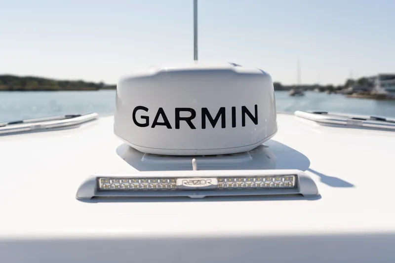 Slide: The Image of 2023 MJM Yachts 4 with chrome horns, docked near waterfront homes. - 18