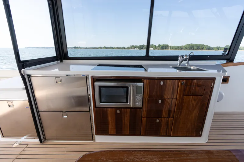 Slide: The Image of 2023 MJM Yachts 4 with dual Mercury outboard engines cruising on open water. - 22