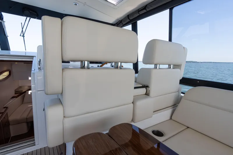 Slide: The Image of Luxurious seating area on 2023 MJM Yachts 4, featuring elegant wood table and scenic water view. - 25