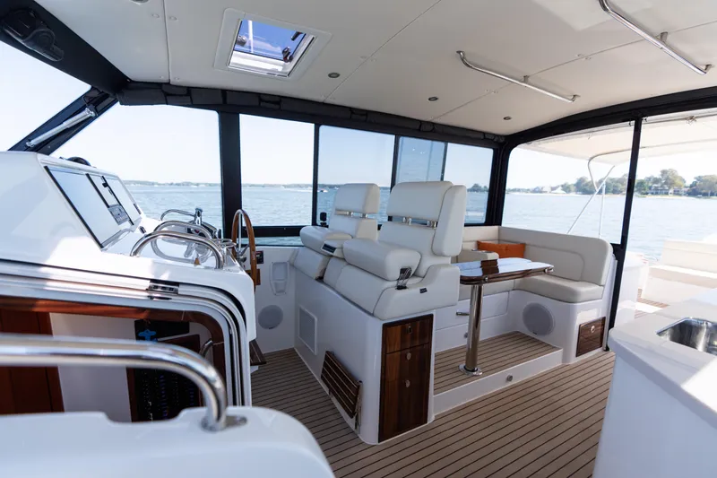 Slide: The Image of Luxurious 2023 MJM Yachts 4 interior with elegant wood table and white seating. - 28