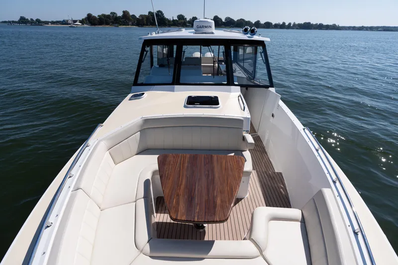 Slide: The Image of 2023 MJM Yachts 4 cruising on water, sleek design, side view. - 3