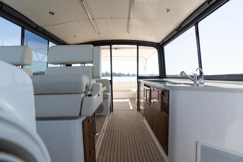 Slide: The Image of 2023 MJM Yachts 4 interior with helm, navigation screens, and cabin entrance. - 32