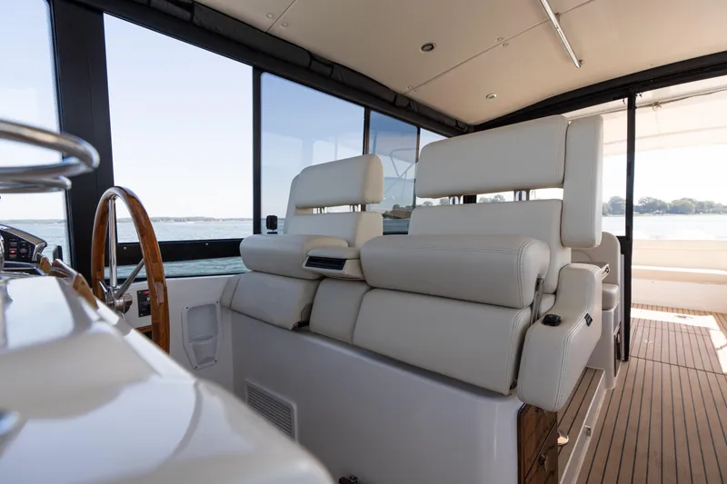Slide: The Image of Interior of 2023 MJM Yachts 4, featuring luxurious seating and modern kitchenette. - 33