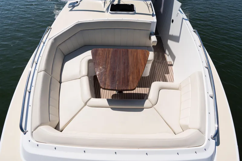 Slide: The Image of Interior of 2023 MJM Yachts 4, featuring luxurious seating and wooden steering wheel. - 34