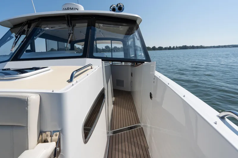 Slide: The Image of Luxurious seating area on 2023 MJM Yachts 4, featuring elegant wood table and scenic water view. - 36