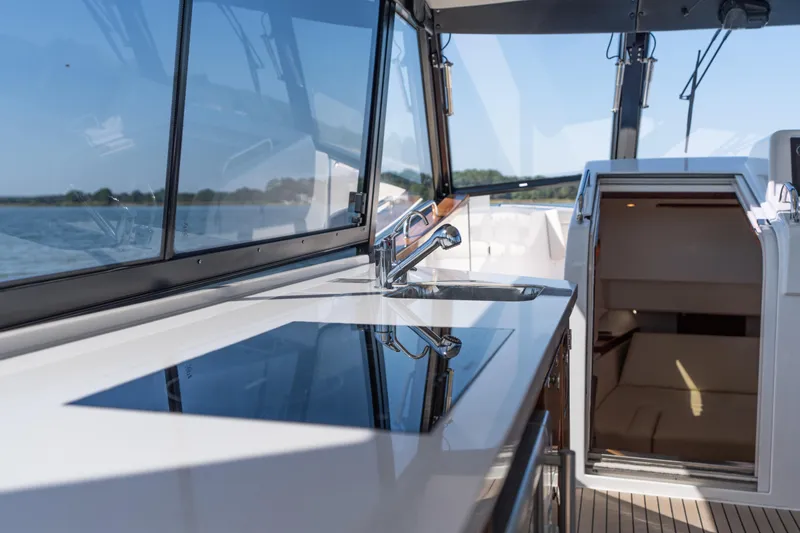Slide: The Image of 2023 MJM Yachts 4 on water, showcasing sleek design and spacious deck. - 37