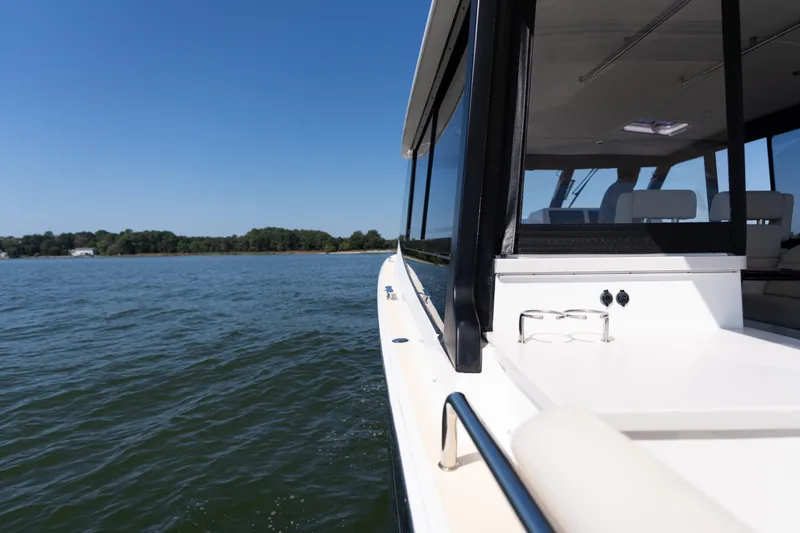 Slide: The Image of 2023 MJM Yachts 4 model, featuring sleek deck design and luxurious seating on open water. - 41