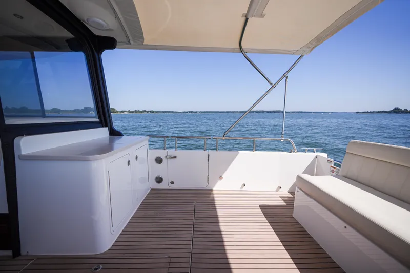 Slide: The Image of Interior view of 2023 MJM Yachts 4, showcasing spacious seating and scenic water backdrop. - 44