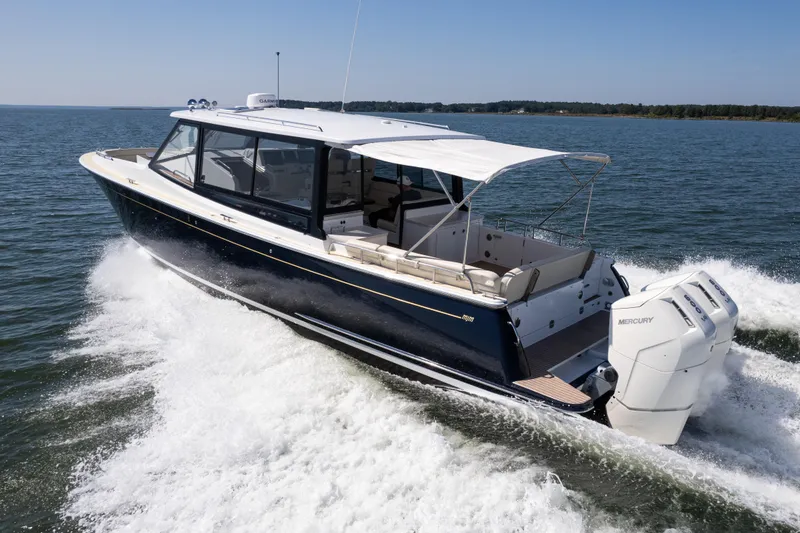 Slide: The Image of 2023 MJM Yachts 4 cruising on open water with powerful Mercury engines. - 50