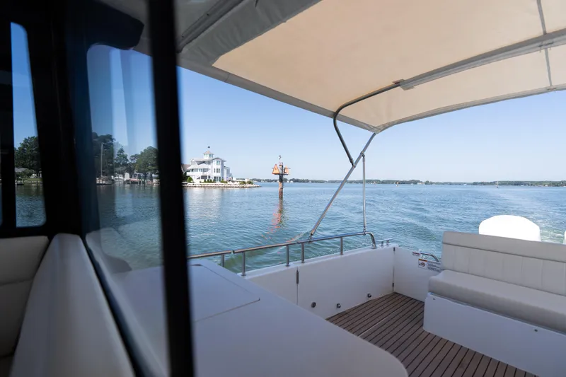 Slide: The Image of 2023 MJM Yachts 4 interior view with scenic waterfront backdrop. - 51