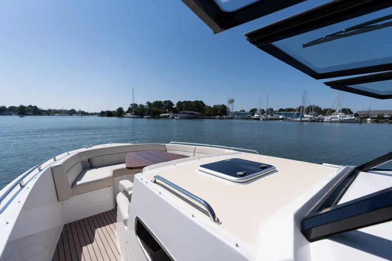 Slide: The Image of 2023 MJM Yachts 4 on calm water, featuring spacious deck and seating area. - 53