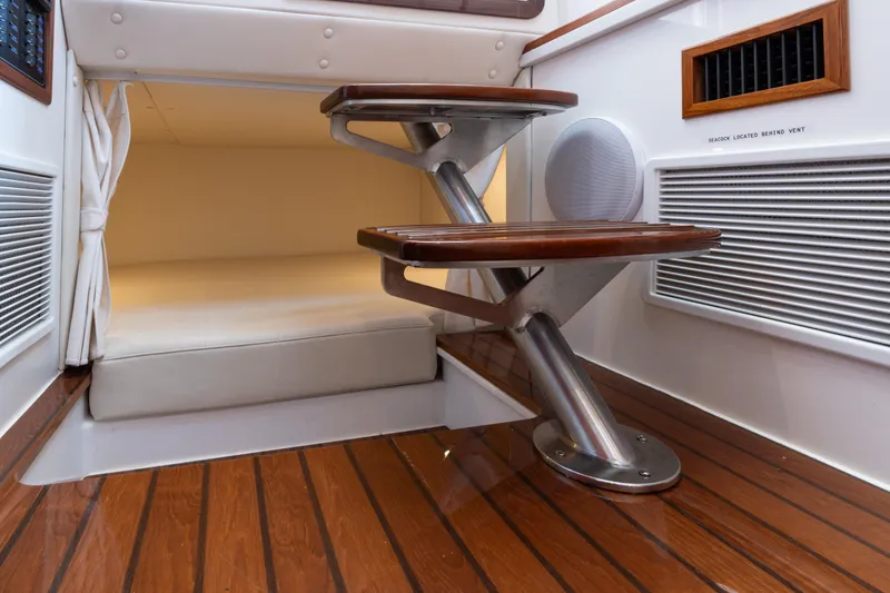 Slide: The Image of Interior of 2023 MJM Yachts 4, featuring wooden steps and a cozy cabin space. - 56