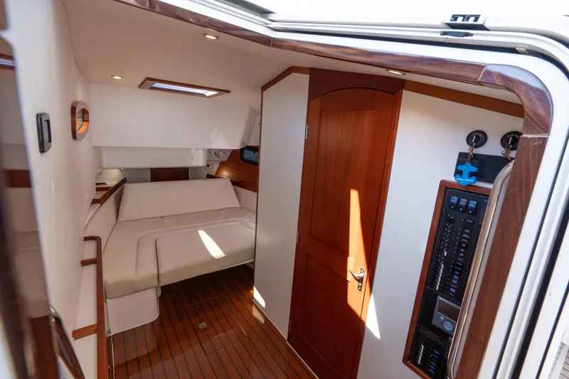 Slide: The Image of Interior of 2023 MJM Yachts 4, featuring elegant wood finishes and cozy seating. - 58