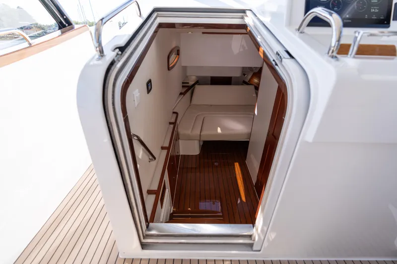Slide: The Image of Interior view of 2023 MJM Yachts 4, showcasing elegant cabin entrance and wooden flooring. - 59