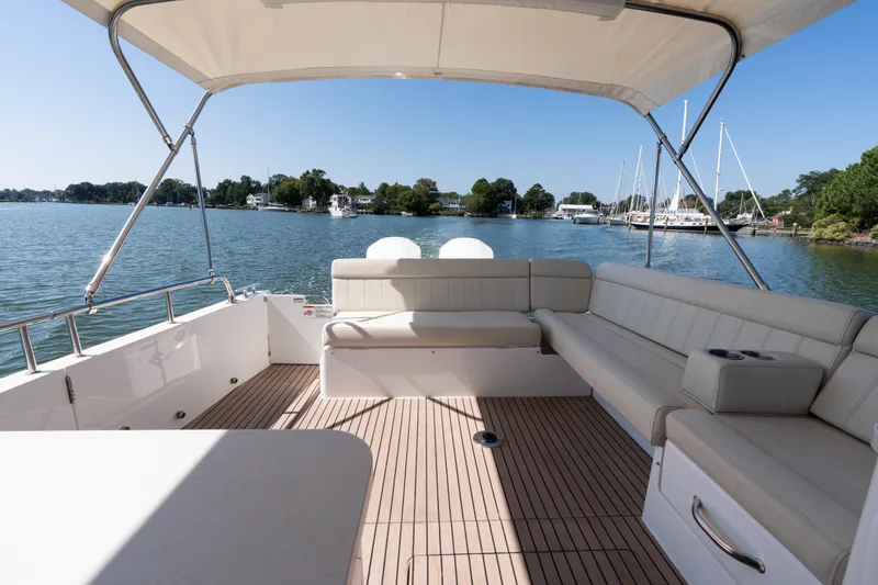 Slide: The Image of 2023 MJM 4 boat interior with spacious seating and scenic waterfront view. - 62