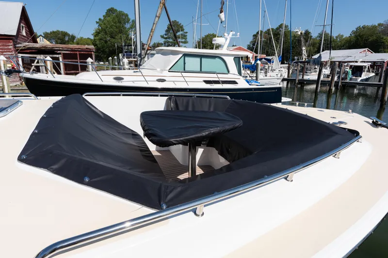 Slide: The Image of 2023 MJM 4 boat with covered seating area at a marina. - 66