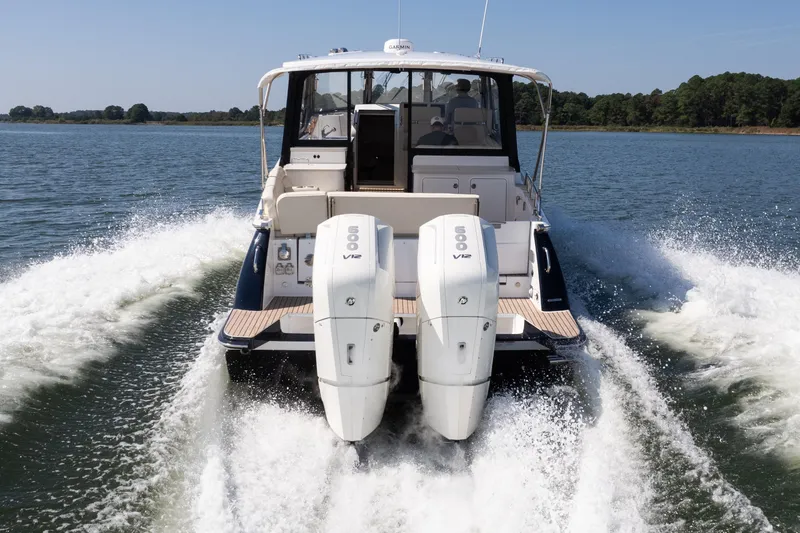 Slide: The Image of 2023 MJM Yachts 4 model, featuring spacious deck and seating, cruising on calm waters. - 7