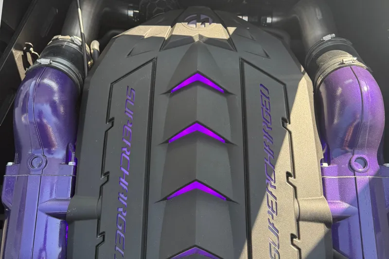 Slide: The Image of 2026 MasterCraft XStar 23 engine with purple accents and supercharger detail. - 12