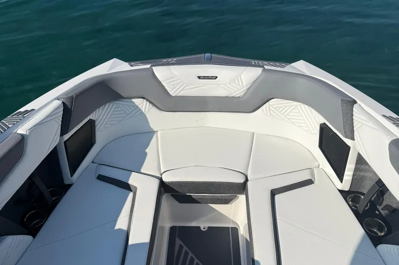 Slide: The Image of 2026 MasterCraft XStar 23 boat interior with sleek white and gray seating. - 4