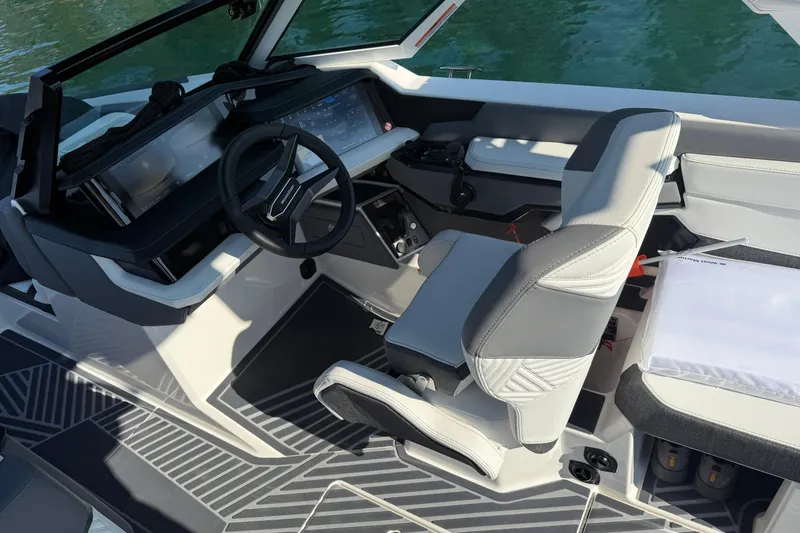 Slide: The Image of 2026 MasterCraft XStar 23 boat interior with modern steering and seating design. - 6