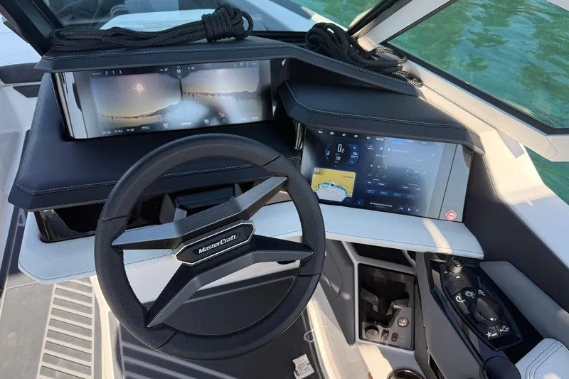 Slide: The Image of 2026 MasterCraft XStar 23 boat dashboard with advanced digital displays and steering wheel. - 7