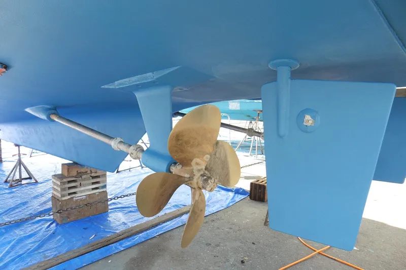 Slide: The Image of 1997 Ocean Alexander 426 Classico Sedan propeller and rudder, dry docked for maintenance. - 112