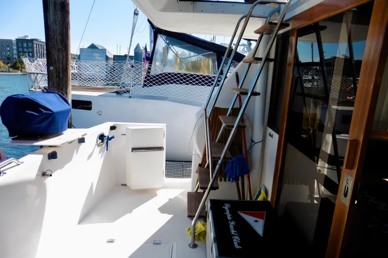 Slide: The Image of 2000 Ocean Alexander 423 Classico yacht docked, featuring sleek white exterior and blue accents. - 12