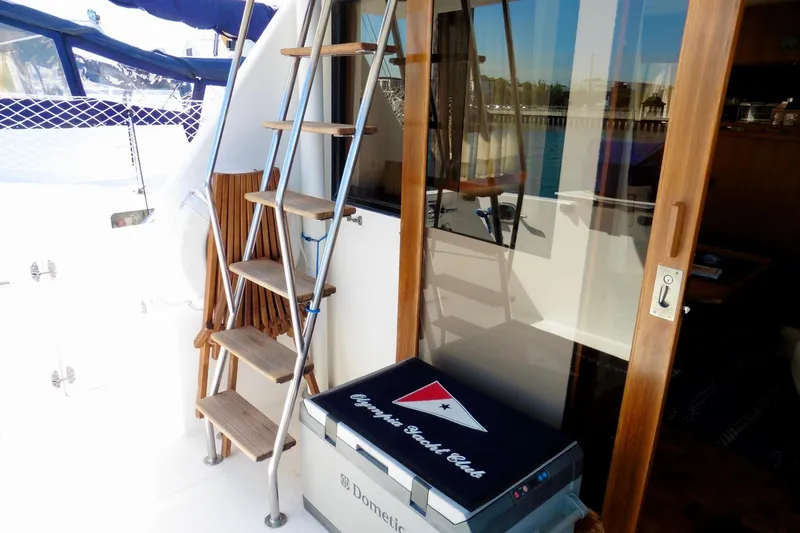 Slide: The Image of 2000 Ocean Alexander 423 Classico boat interior with blue canopy and steering area. - 26