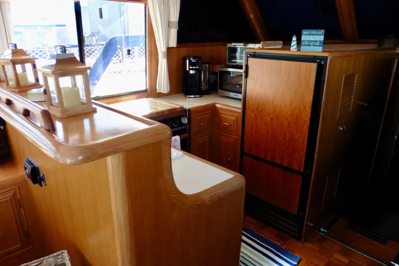 Slide: The Image of Interior of 1997 Ocean Alexander 426 Classico yacht with cozy seating and wooden accents. - 34