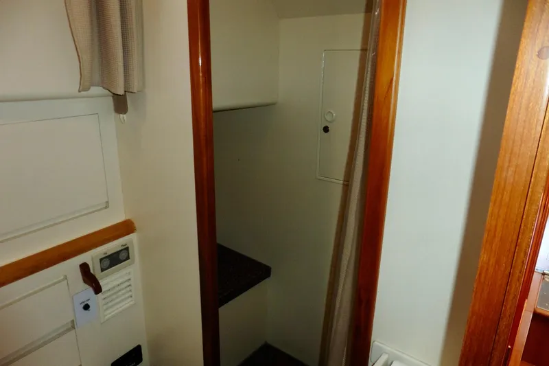 Slide: The Image of Control panel and remote for 2000 Ocean Alexander 423 Classico yacht, featuring navigation controls. - 57