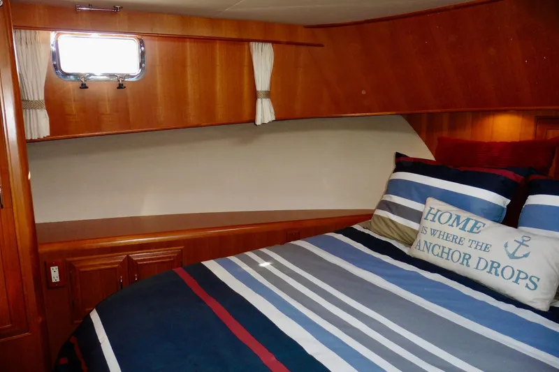 Slide: The Image of Wooden cabin interior of 2000 Ocean Alexander 423 Classico yacht with storage and bed. - 66