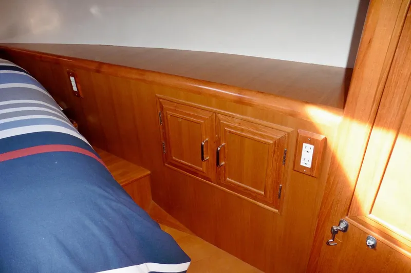 Slide: The Image of Bathroom interior of 1997 Ocean Alexander 426 Classico yacht, featuring toilet and porthole window. - 69